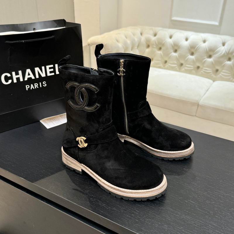 Black suede mid-calf boots with embossed logo emblem and gold-tone hardware, side zipper closure and chunky lug sole